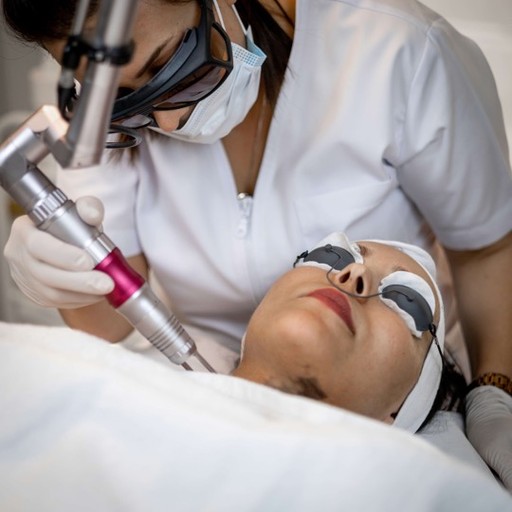 A skin specialist at Bella Medical Centre in Abu Dhabi performing a treatment with protective glasses on. 