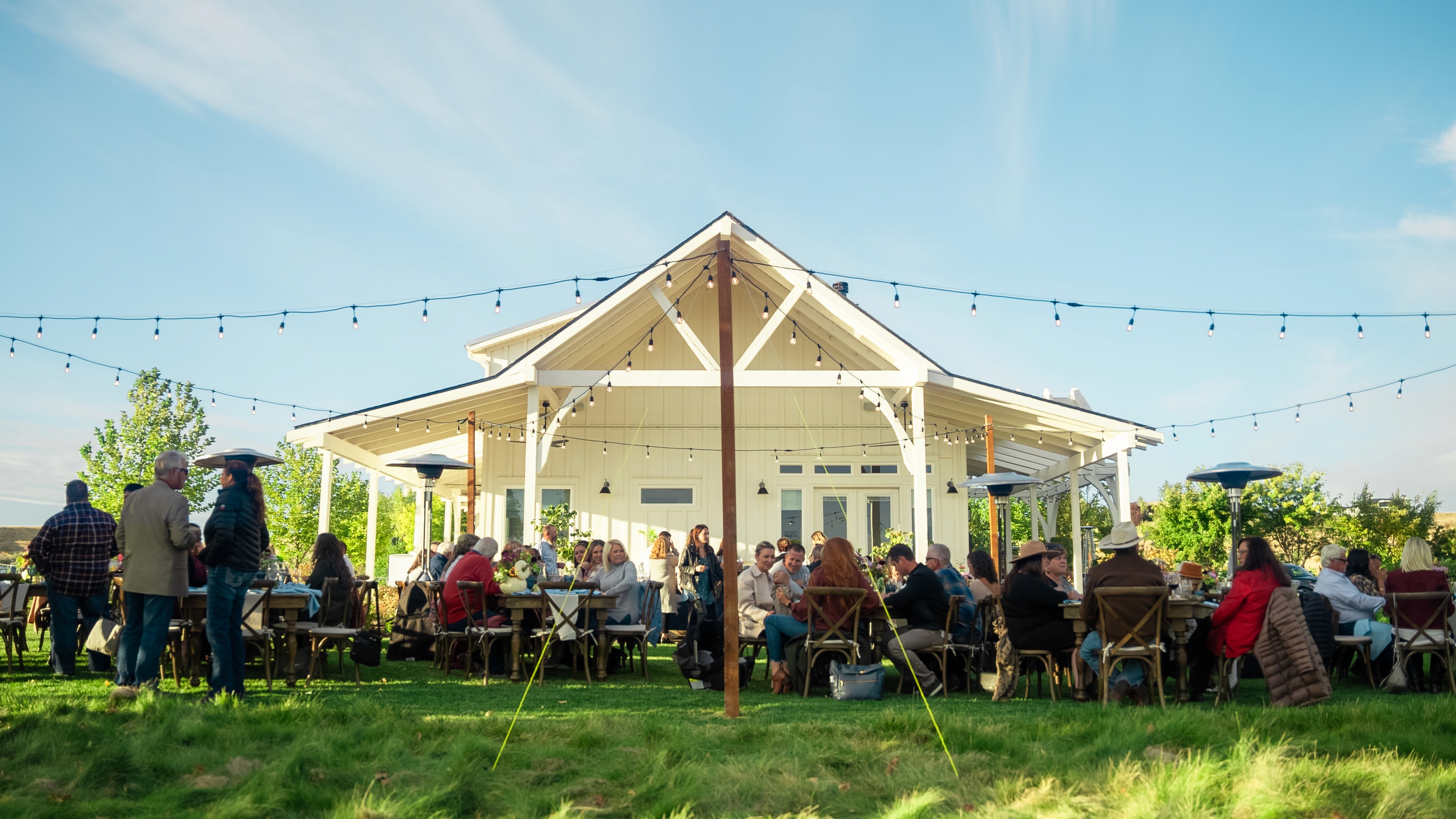 Guests gathered outside the Rolling Hills Vineyard homestead during an Idaho wine event