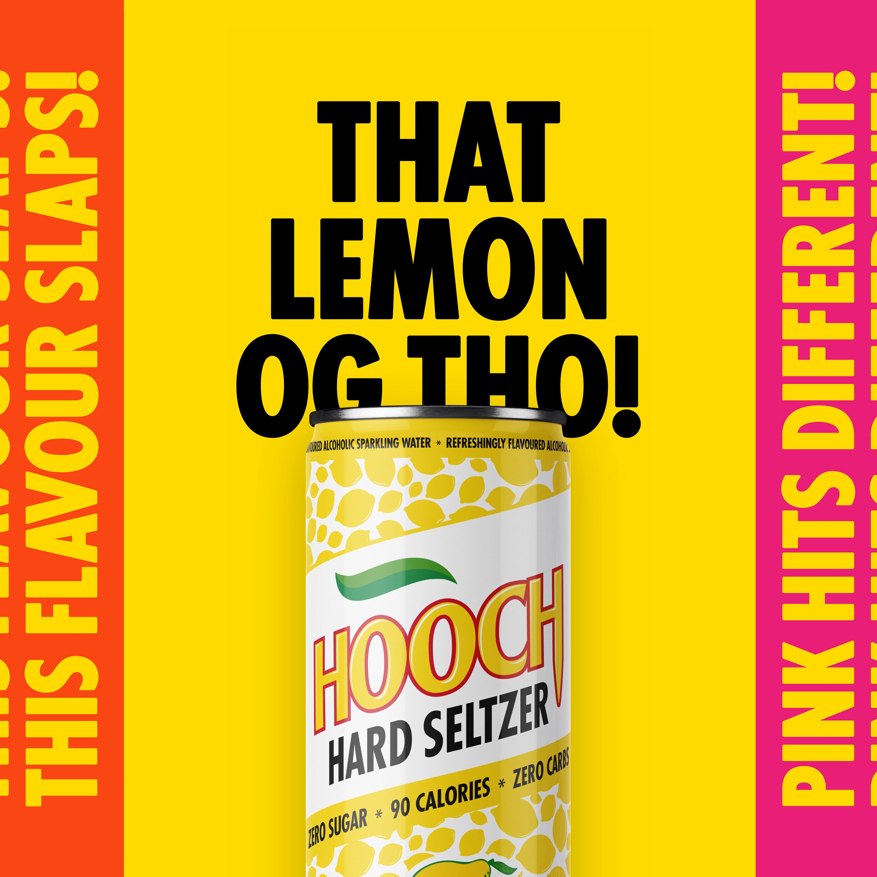 Person wearing black clothing carrying a black tote bag with a green globe-like geometric symbol, standing against a concrete wall in sunlight and shadow.