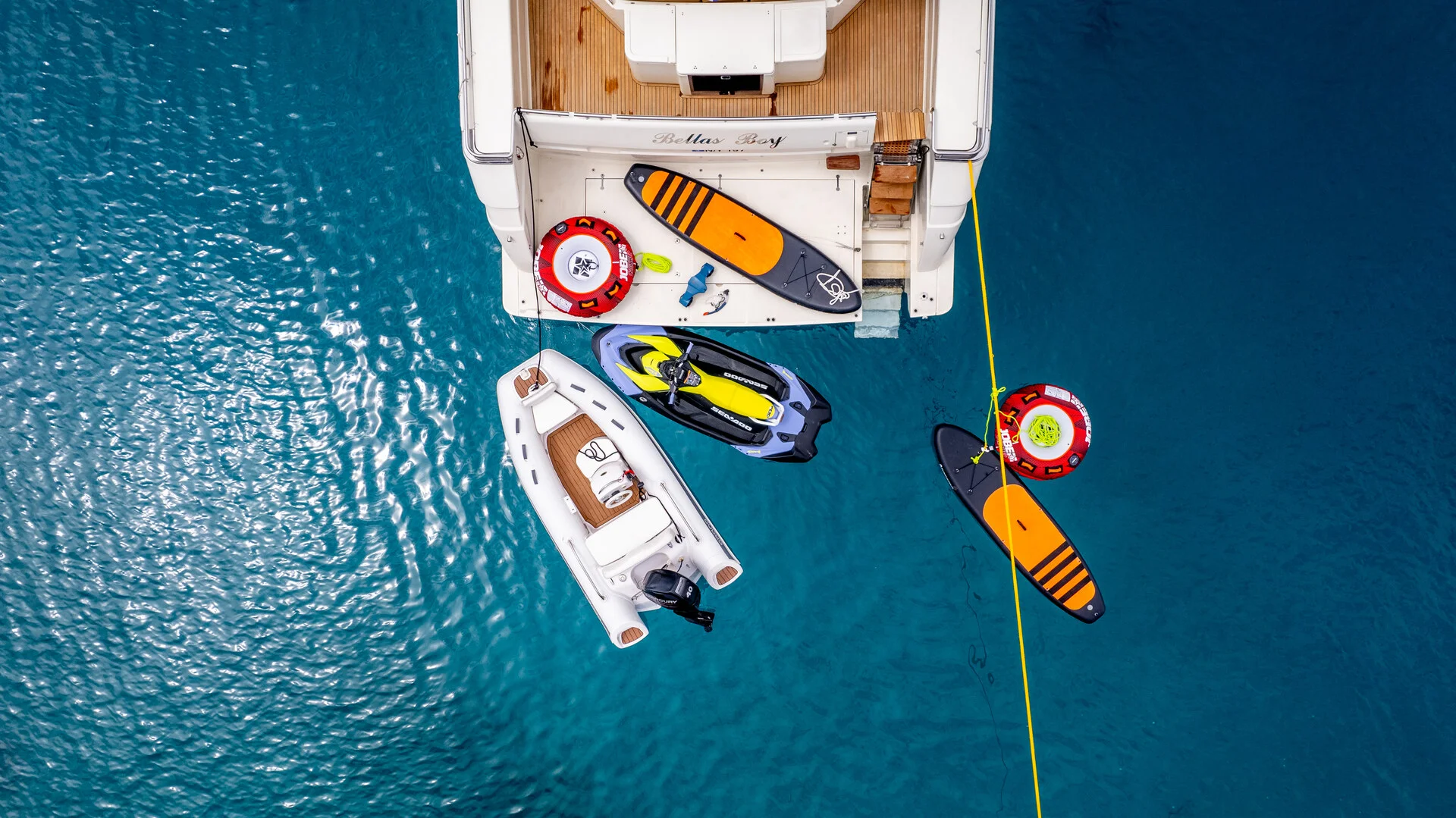 White Rock 36 speedboat with captain at helm cruising calm blue waters near Paros coastline with hills in background.