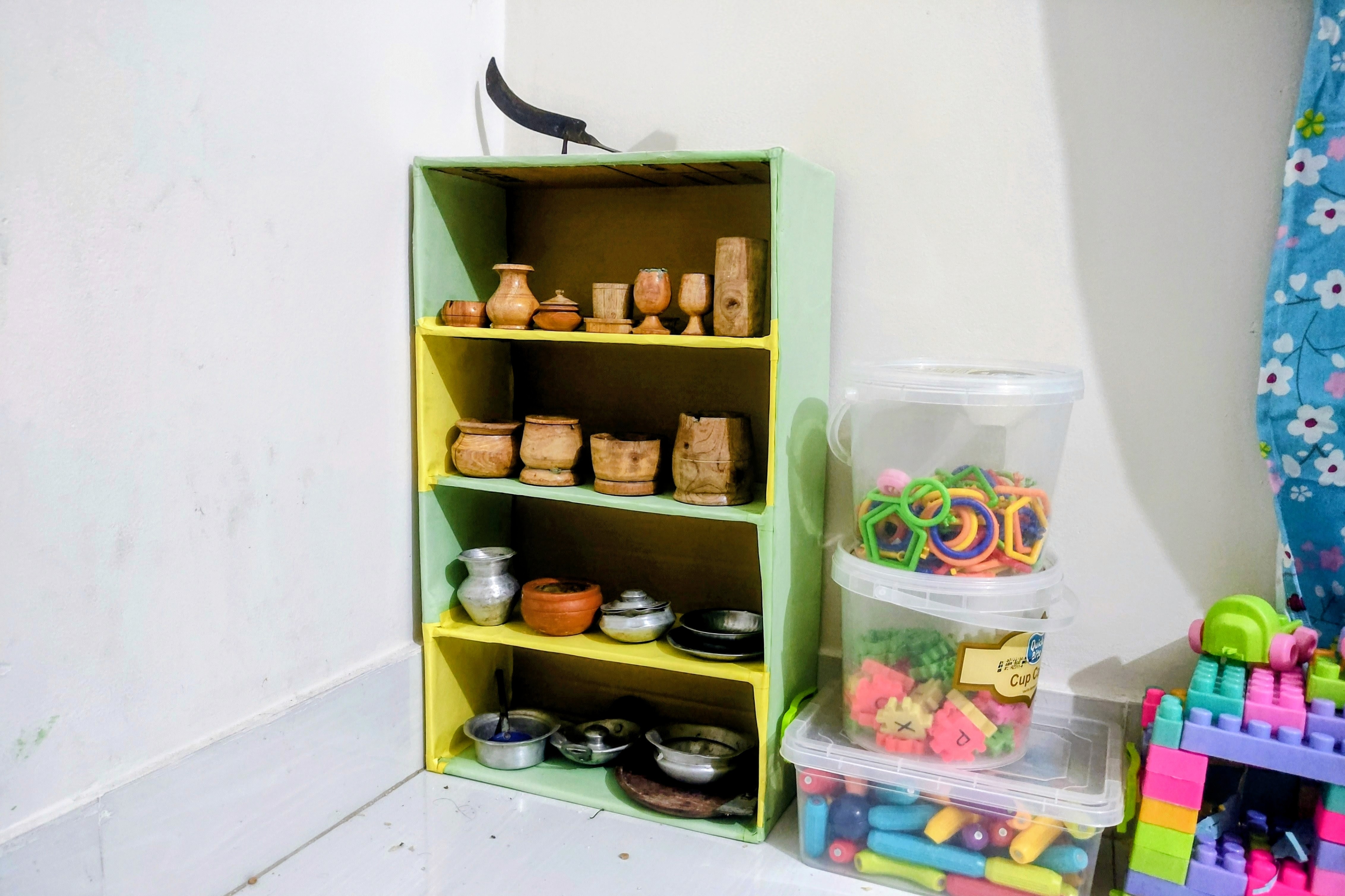 I built a bonus DIY storage rack to help her keep her new playhouse