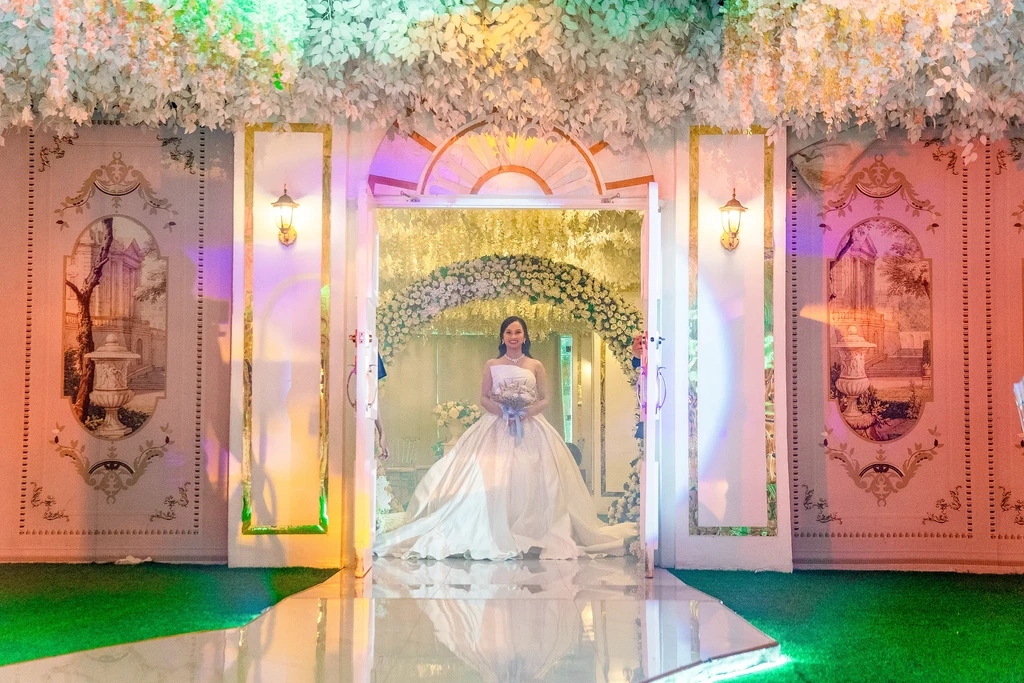 Bride at the enchanted doorway of Celestia Hall in violet evening light