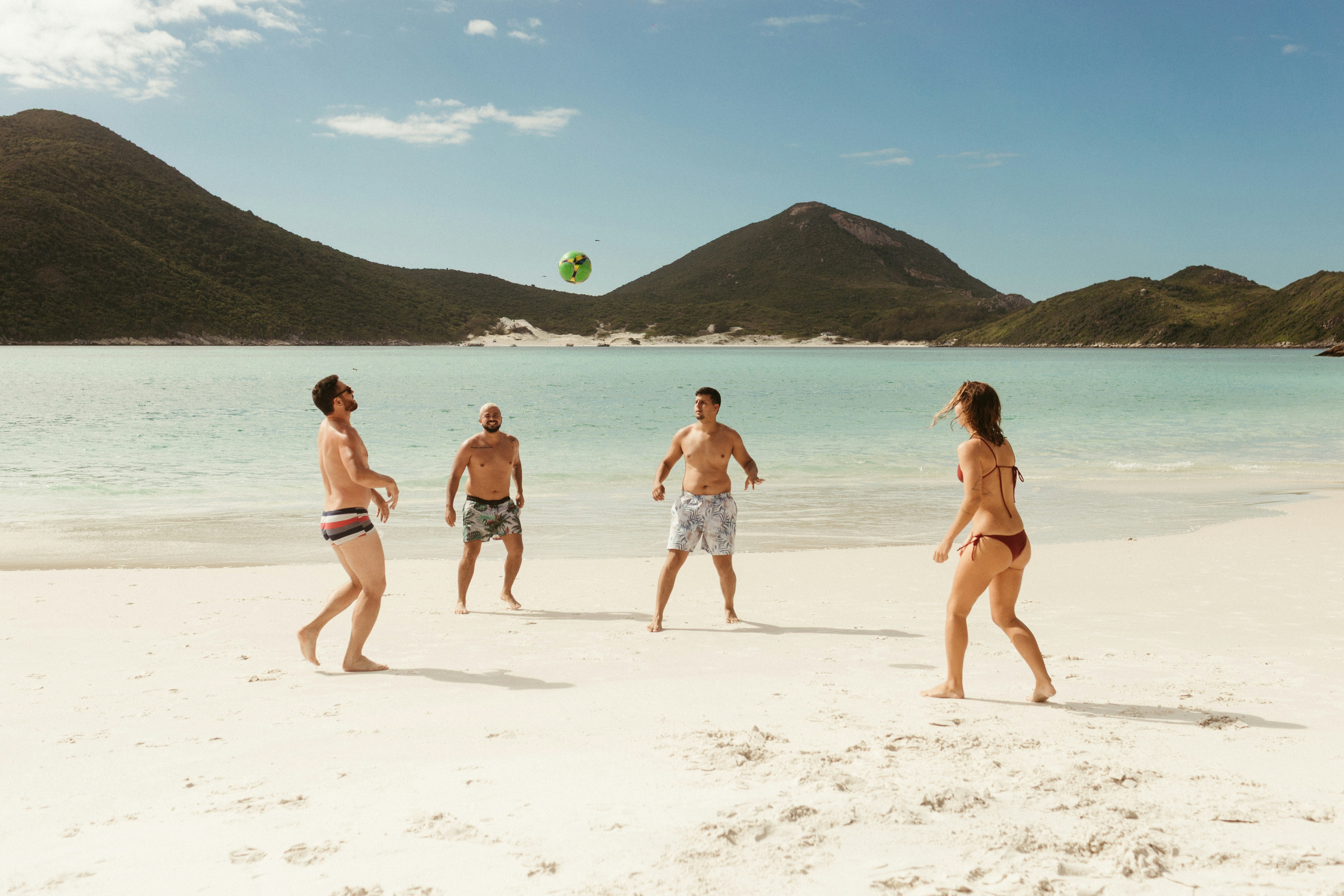 People playing volleyball on a sandy beach