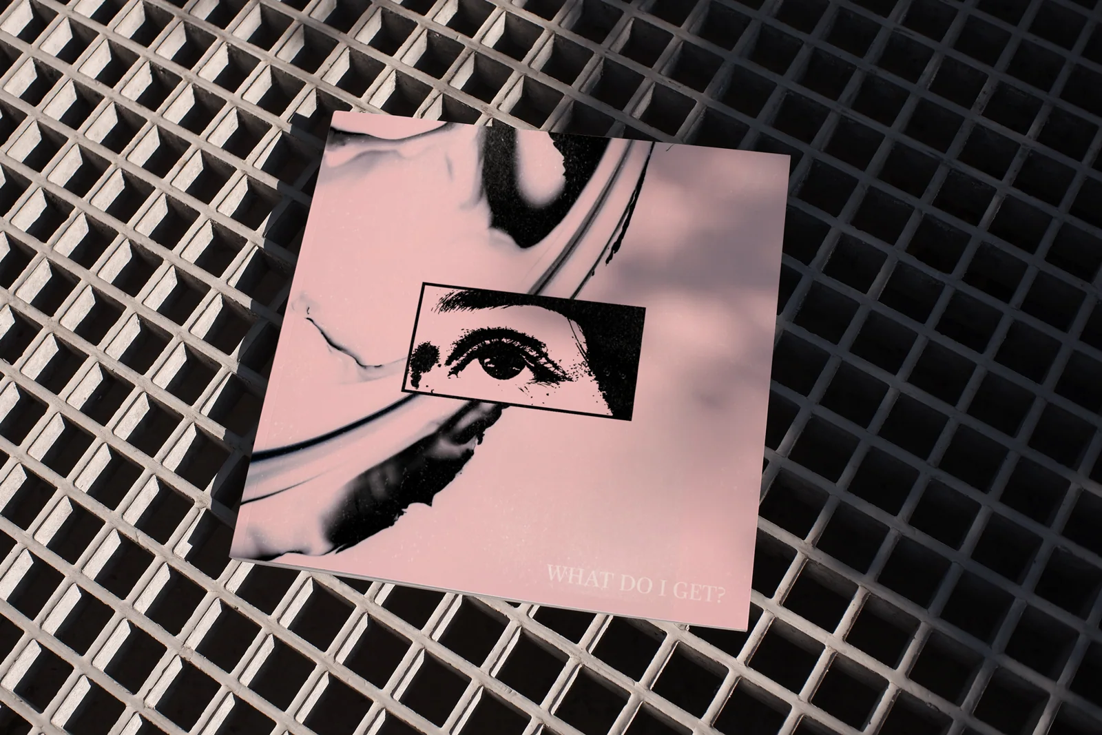 Pink bag with a black eye graphic placed on a metal grate.