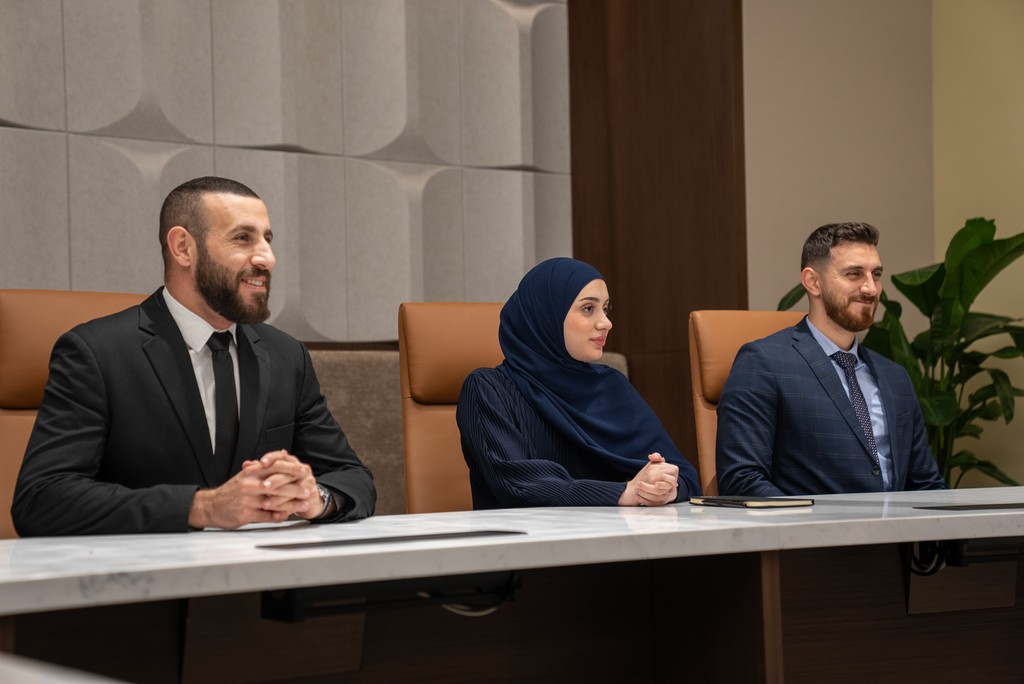 Professional working in quiet booth reviewing documents related to Tawtheeq Registration process.