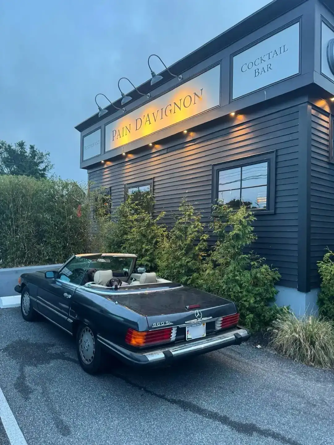 Classic convertible parked outside Pain D’Avignon restaurant exterior.