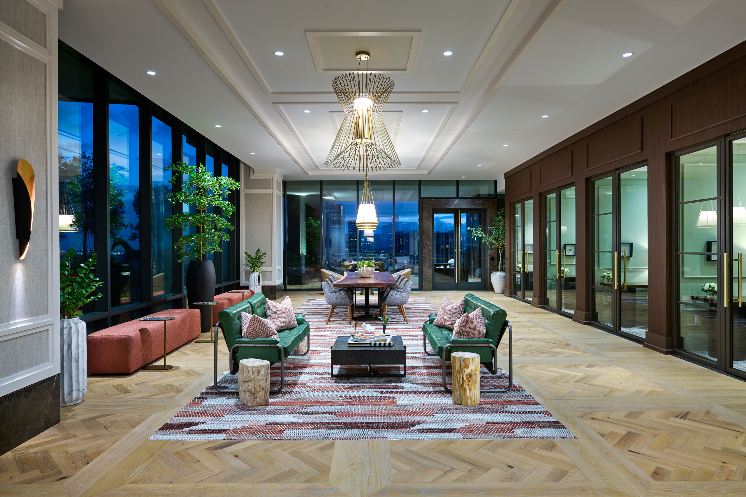 Modern lounge with seating, dining table, and large windows.