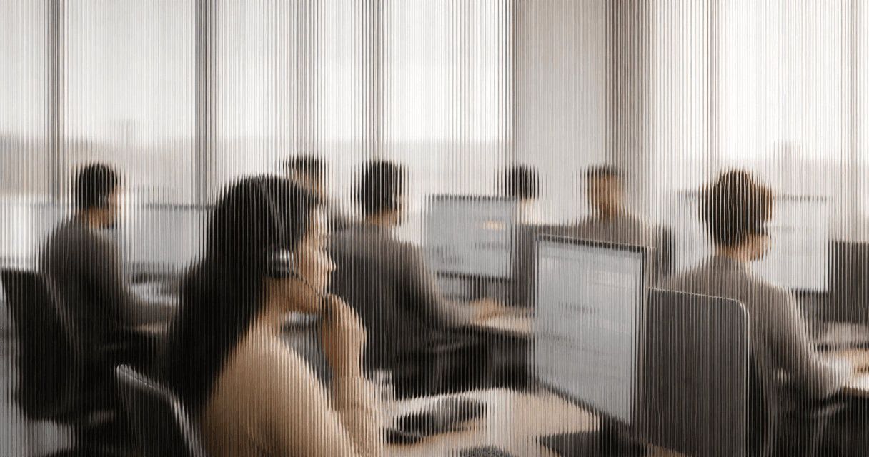 Outbound contact-center floor with sales reps on headsets at their desks, seen through vertical fluted glass