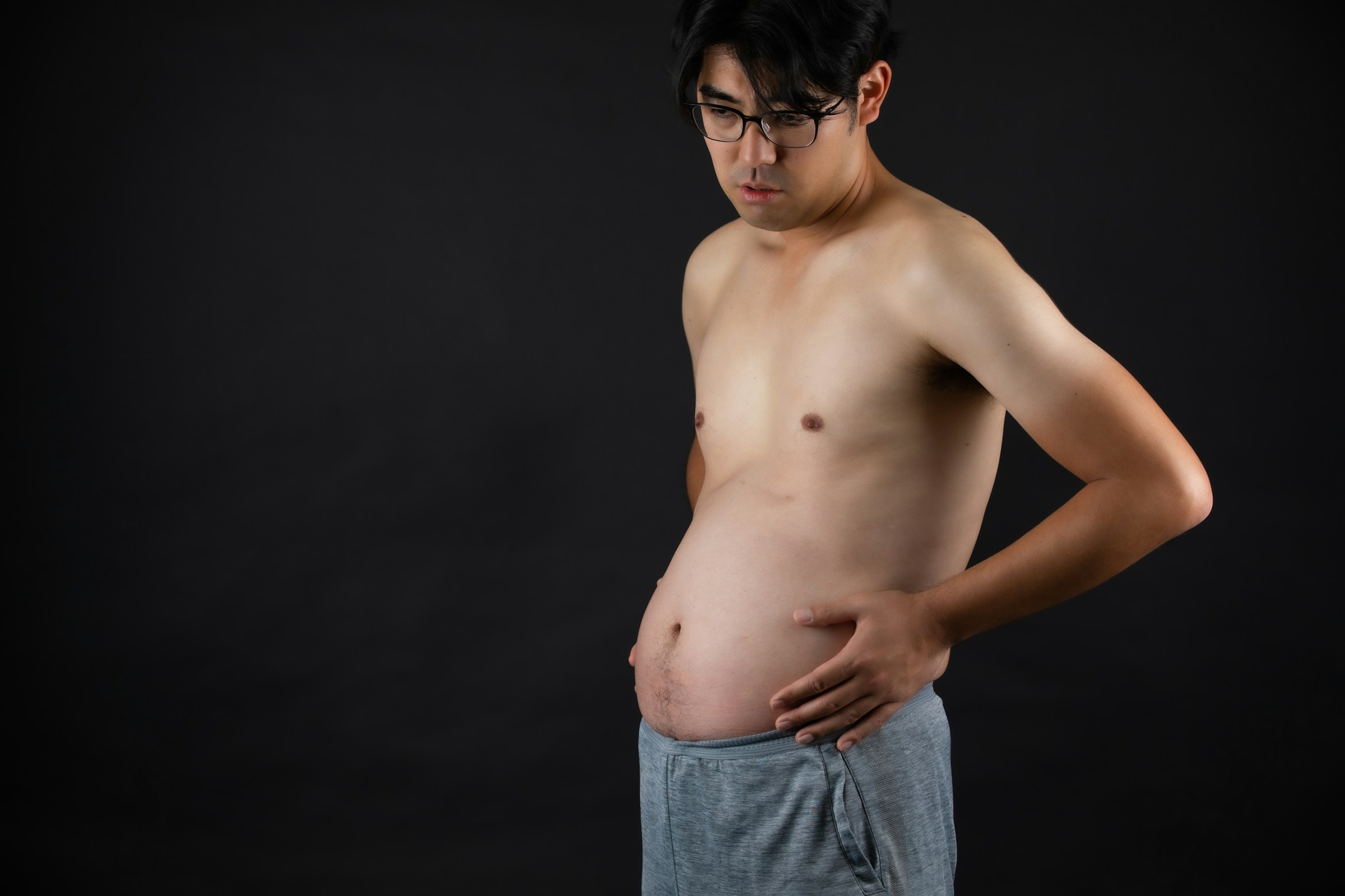 fat man holding tummy - NoFap Weight Loss