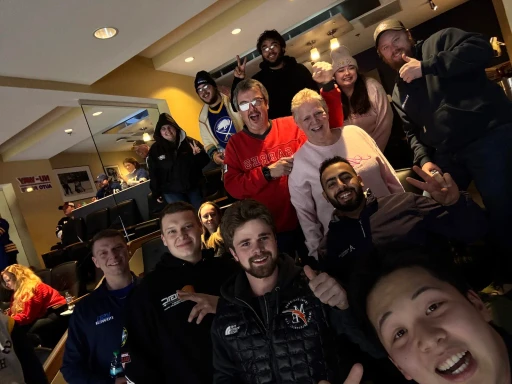 Group photo of VSG Power team members smiling at an indoor event.