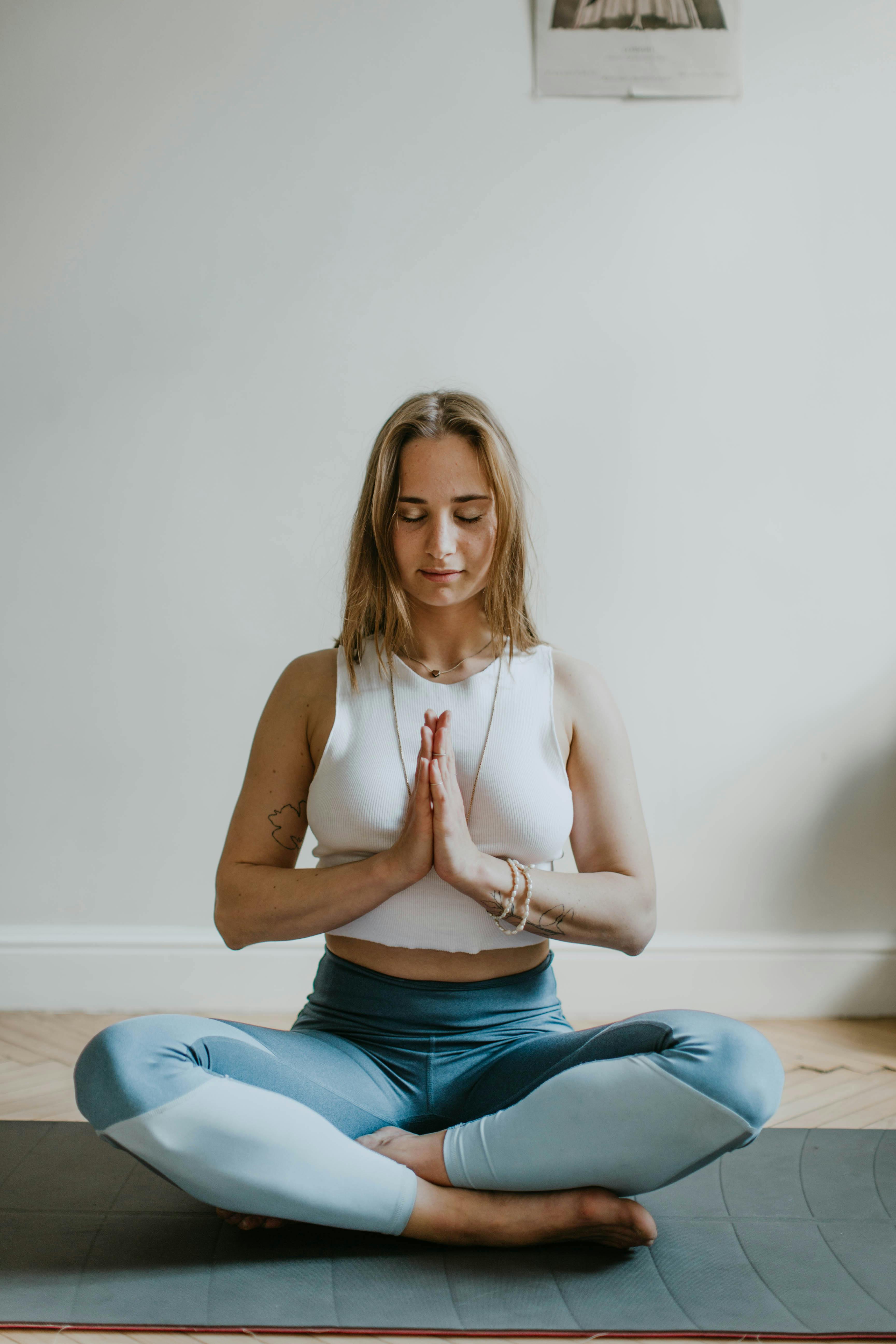 Woman meditating with hands in prayer pose