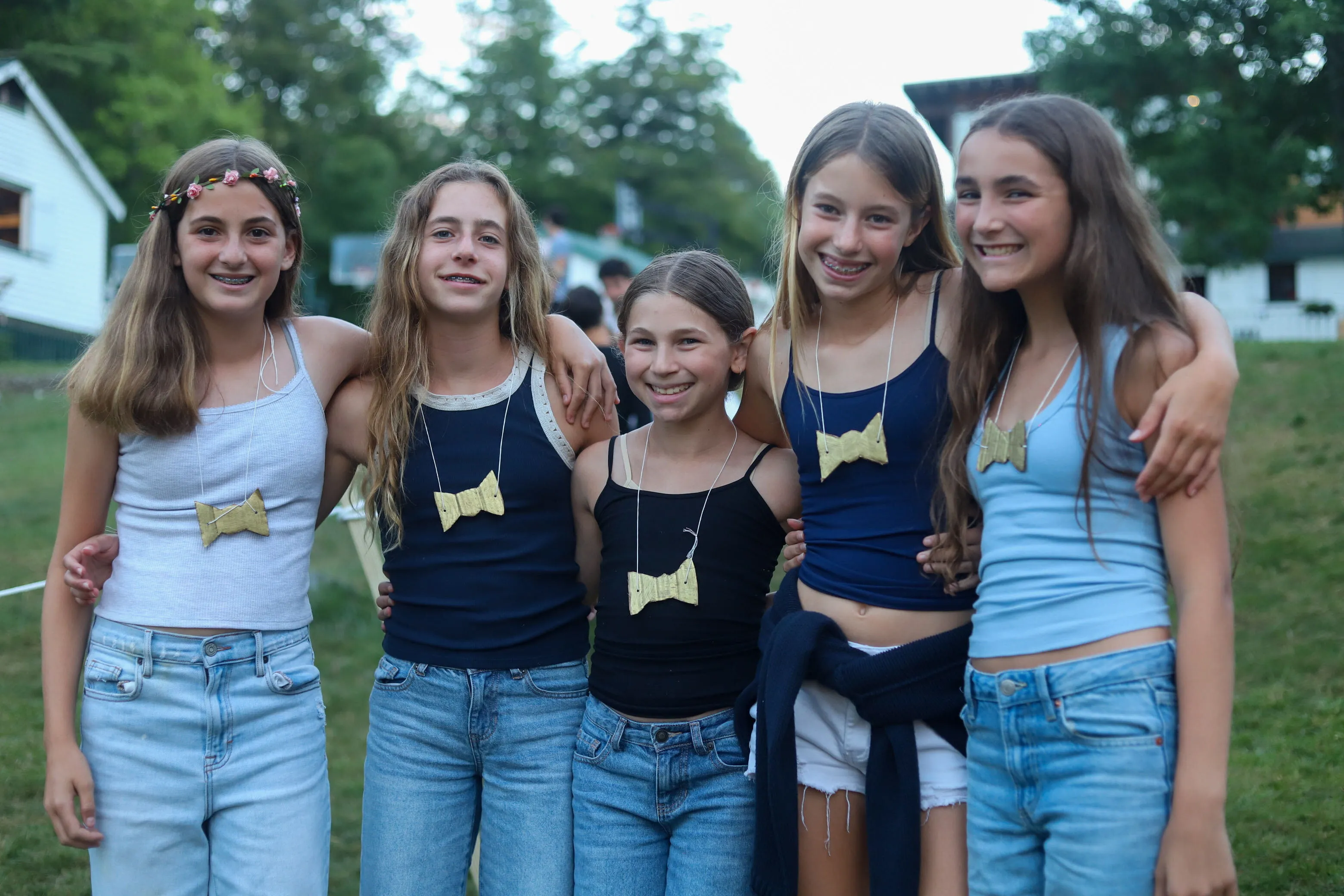 Group of campers posing together at an evening event at Camp Lenox