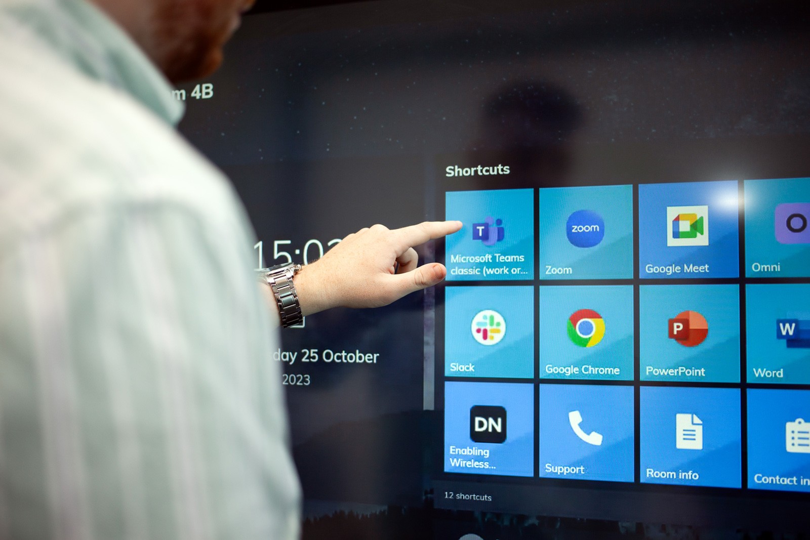 A meeting room user interacting with the shortcuts on the home screen
