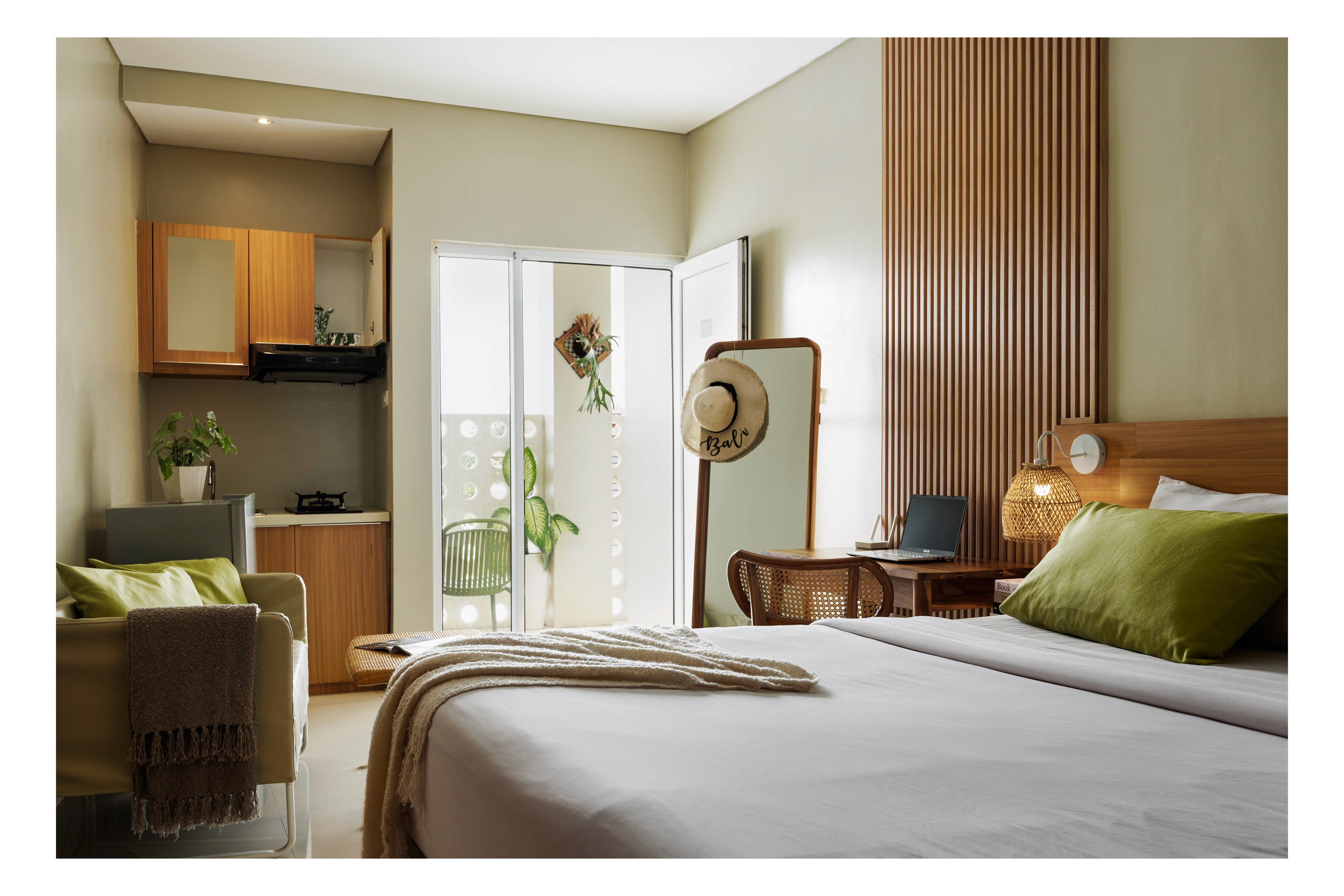 Editorial view of Deva Bali Apartment bedroom interior with wooden panel wall
