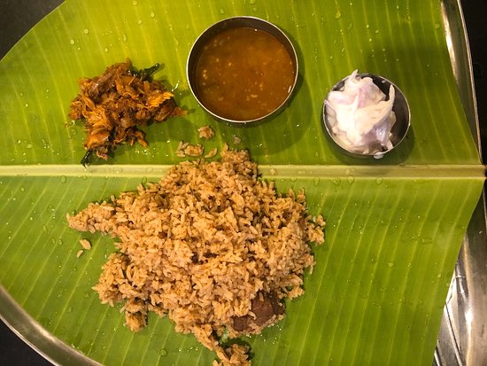 Mutton biryani laid out on a banana leaf