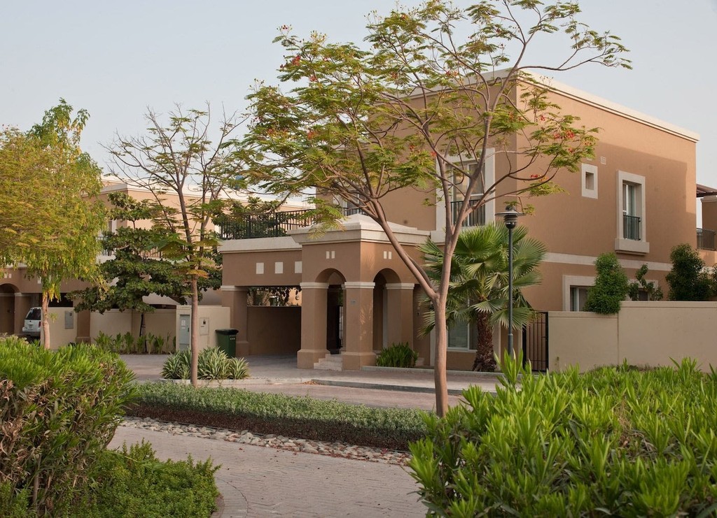 A house named Semmer Villas with a driveway and trees in front, set in a serene residential area.