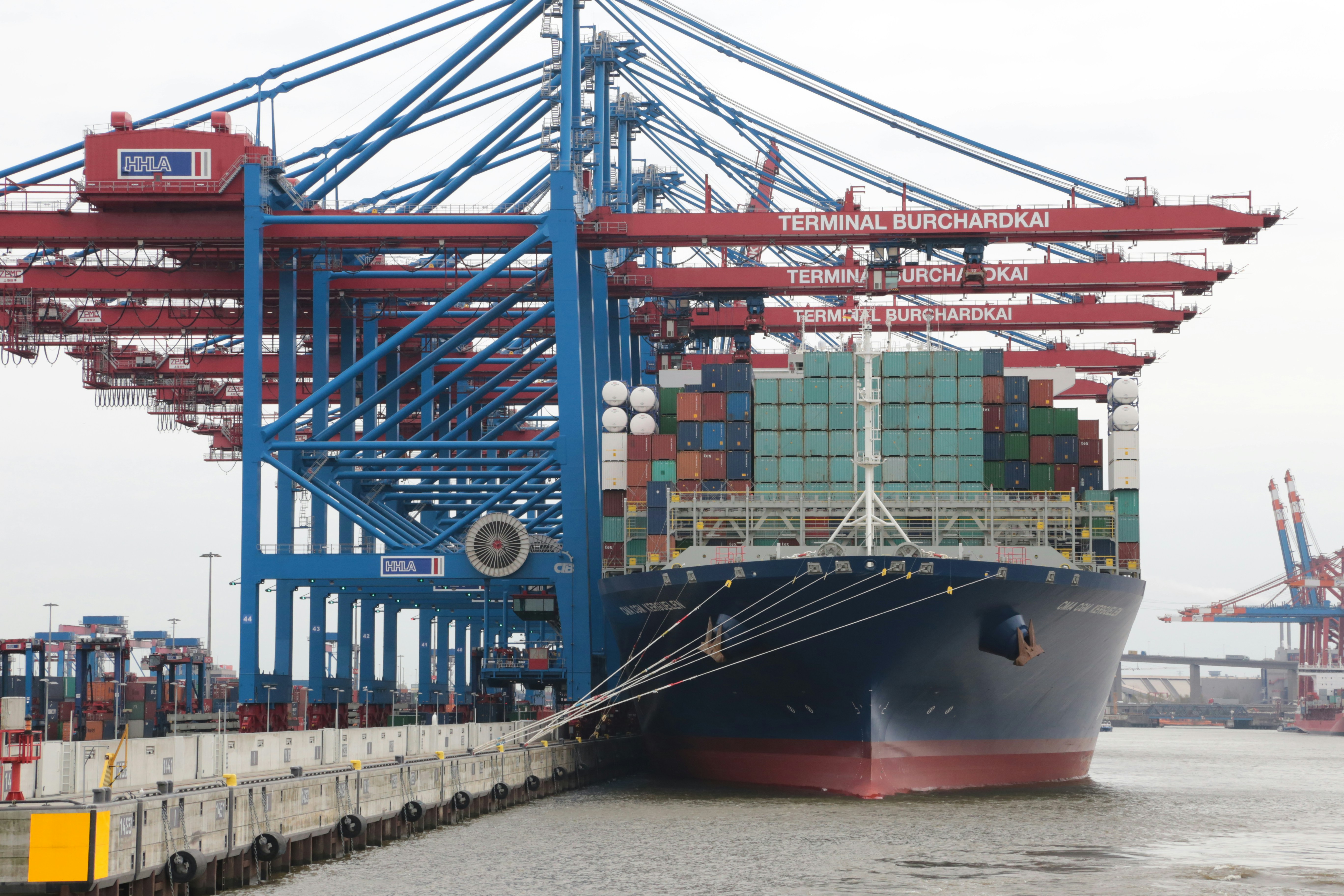 blue and red cargo ship on sea during daytime