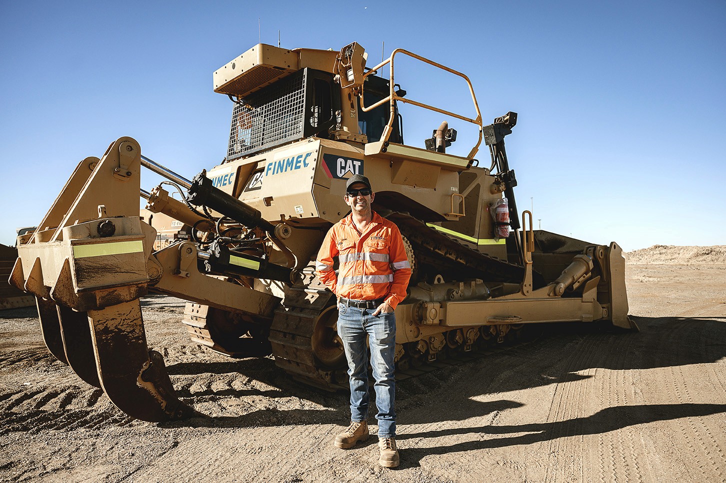 Cluster of translucent pink glass pendant spheres hanging on white—modern lighting décor.