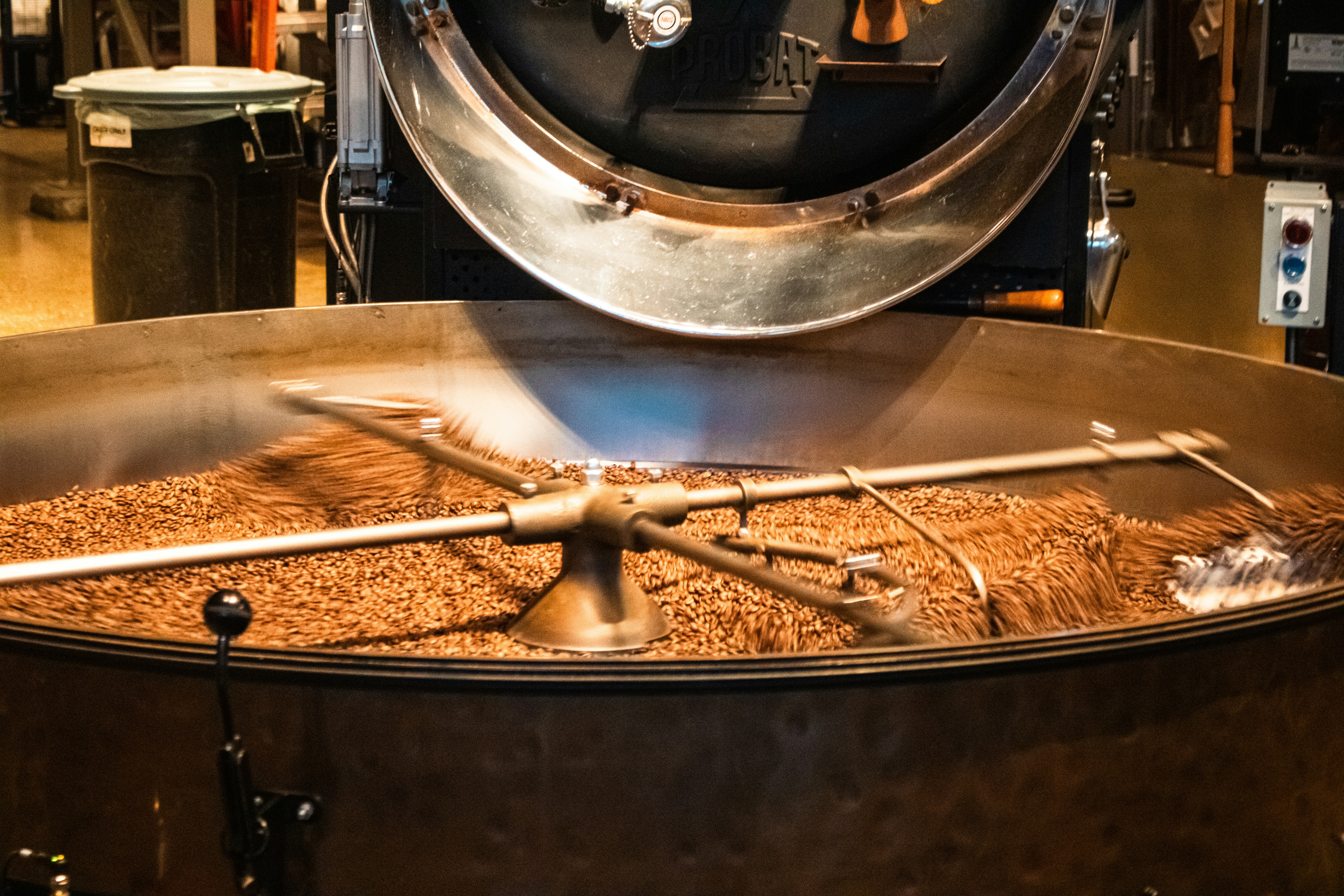 Grain being stirred in an open copper mash tun