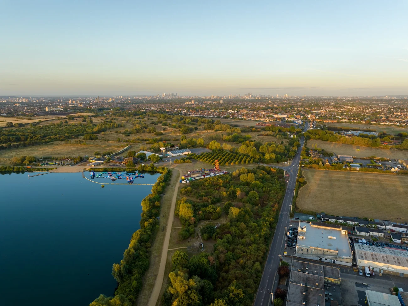 Aerial panorama for virtual tours showing a lake with a water park and landscape at sunset