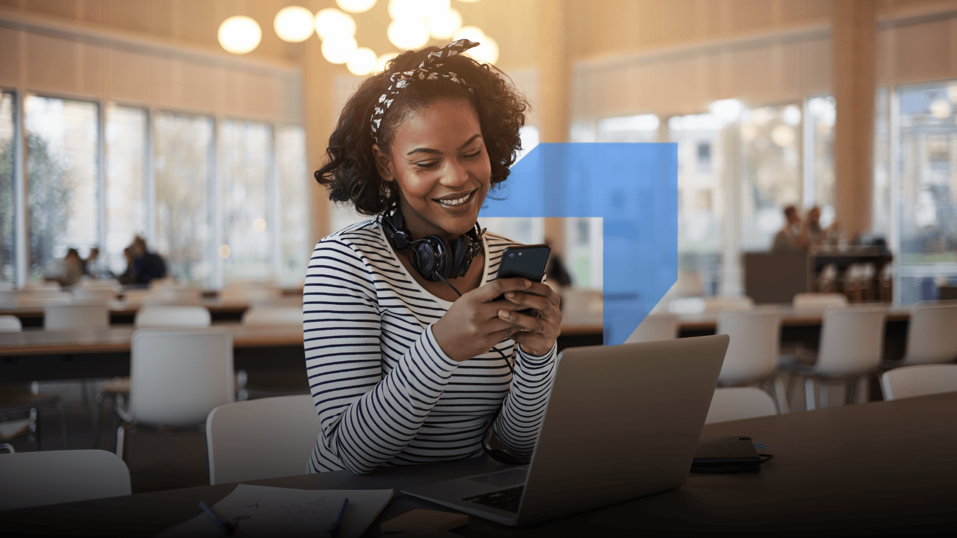 A smiling woman using a smartphone in the foreground