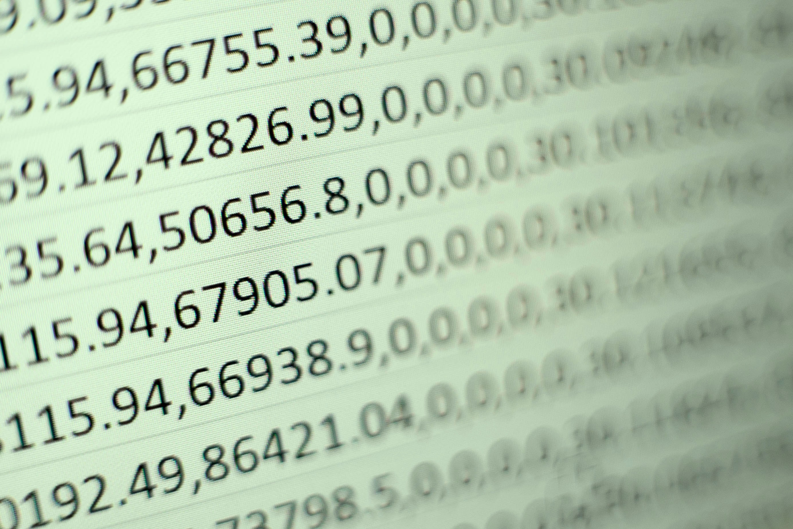 A close-up view of a computer display showing rows of numbers against a green background..