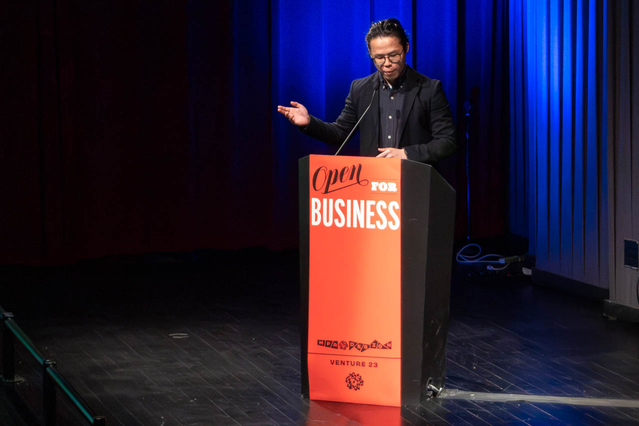 man standing at a podium delivering a presentation