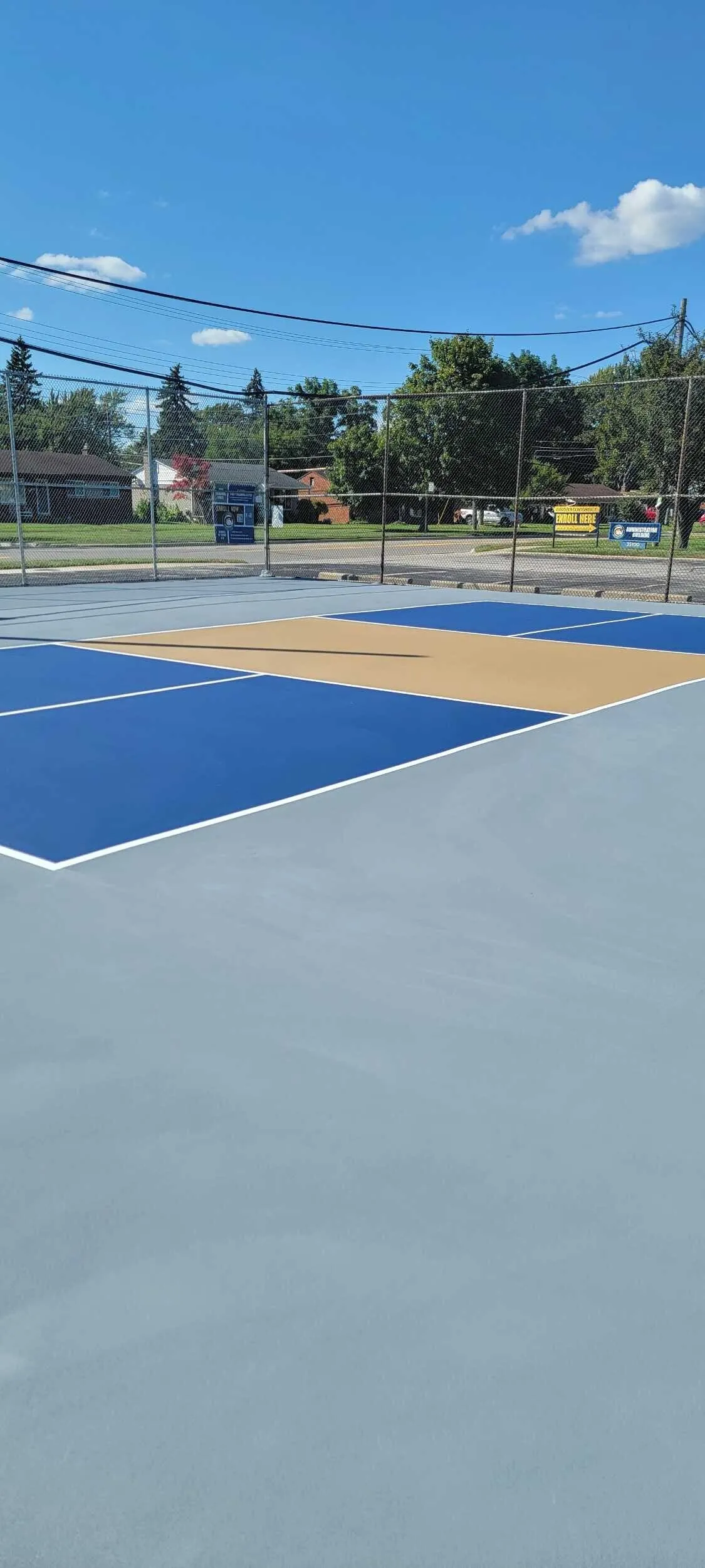Completed pickleball court conversion with fresh three-color acrylic surface and white striping in Clinton Township, MI