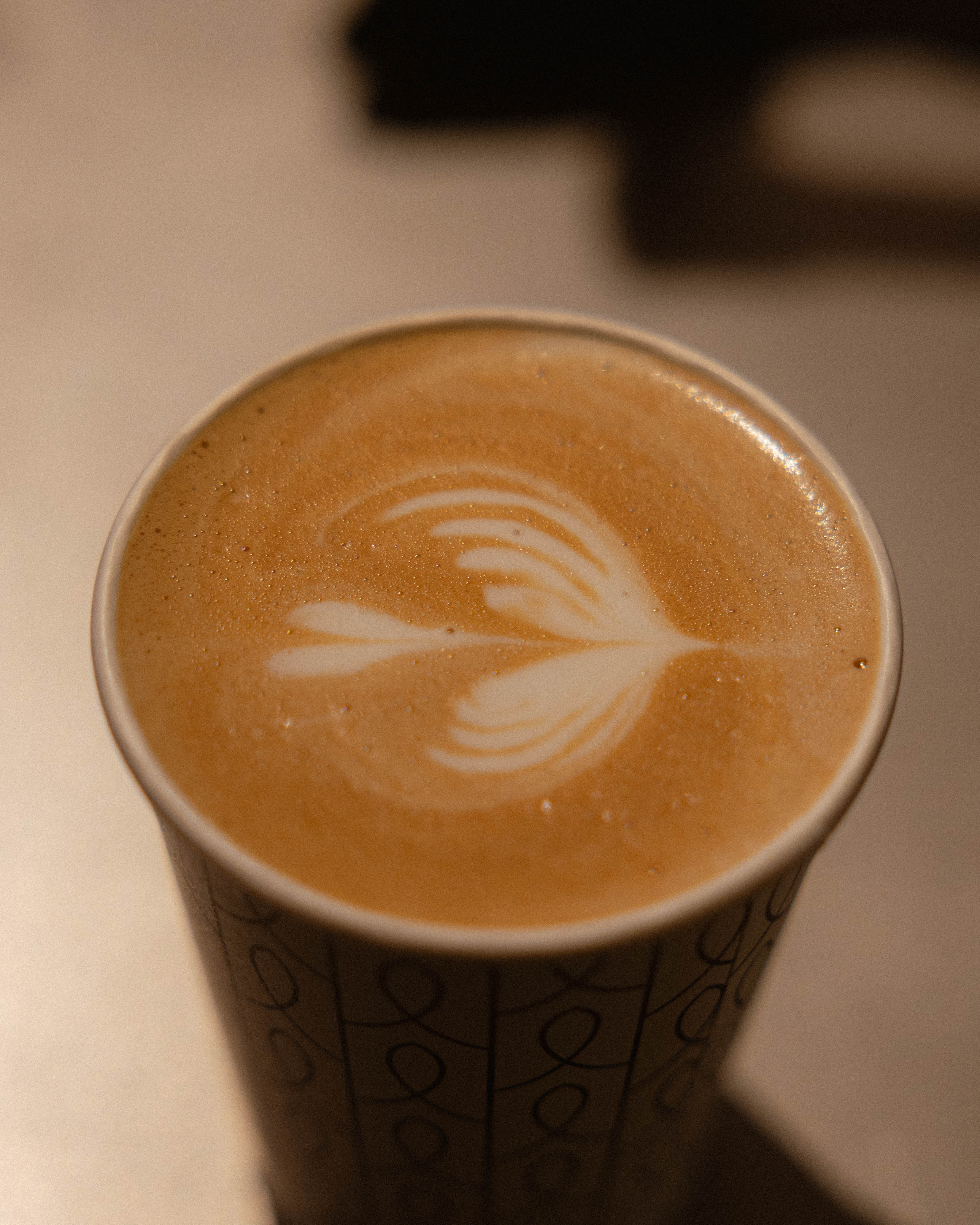 a hand holding a cup of coffee