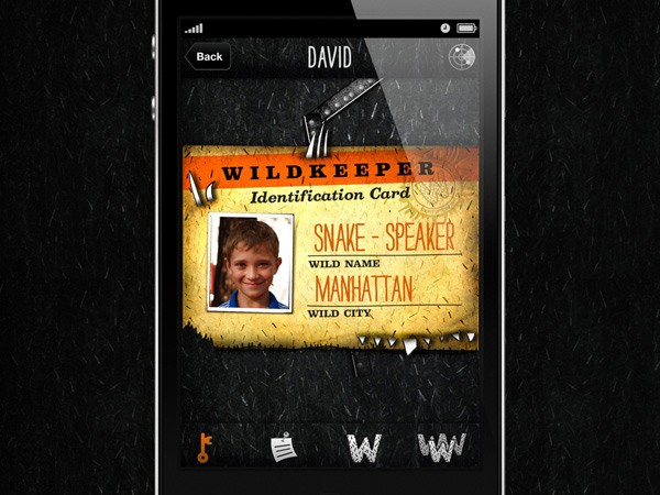 A smartphone displays a stylized identification card with a yellow background and torn edges. The card features the name “SNAKE-SPEAKER” in bold orange letters, with “WILD NAME” and “MANHATTAN” written below in smaller text. A child’s photo is centered on the card. The card’s background has a textured, dark appearance. The phone’s interface includes icons at the bottom: a key, a document icon, a note icon, and a “W” icon. The name “DAVID” is displayed at the top of the screen.