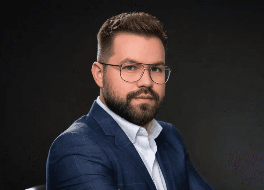 young man standing in front of a building