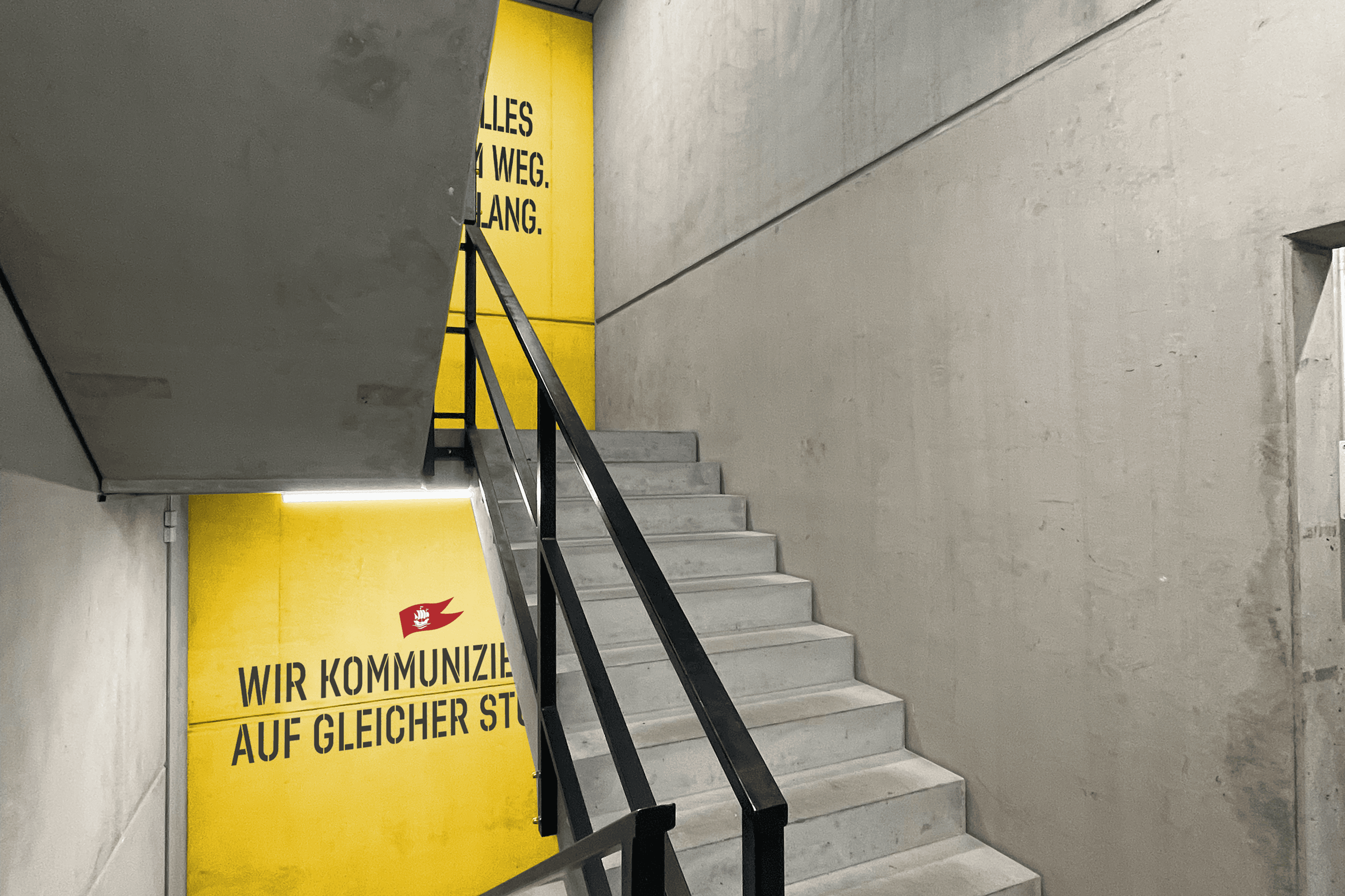 Staircase with yellow wall signage.