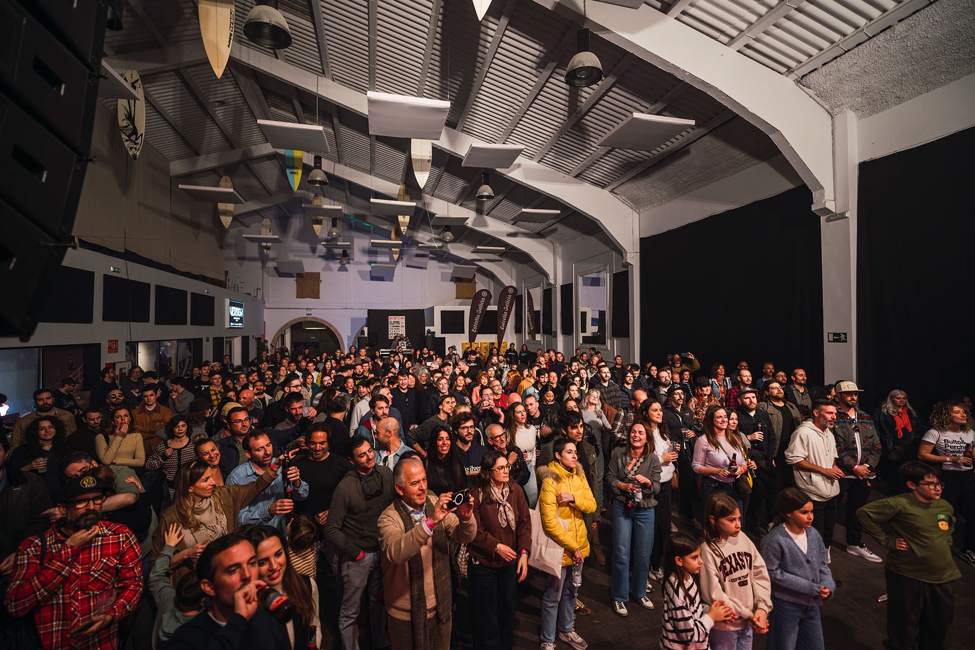DJ playing music surrounded by dense indoor plants.