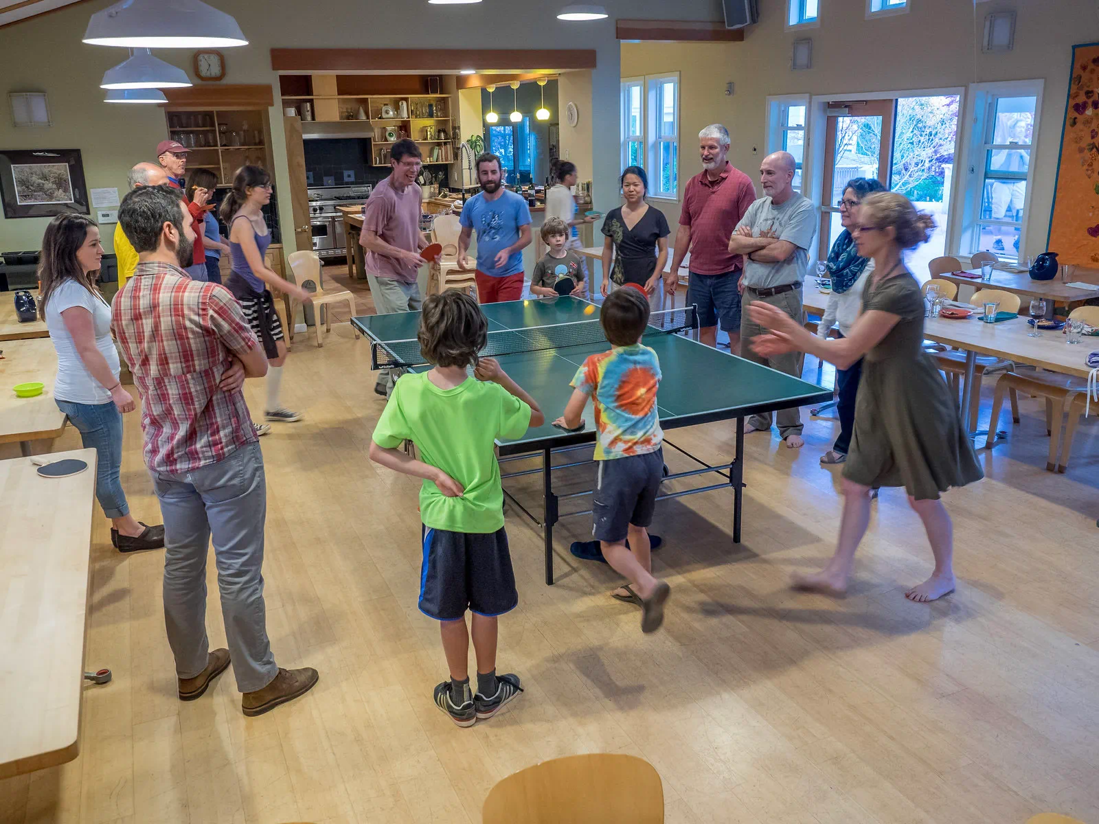 Residents of different ages gathered together in a shared indoor community space.