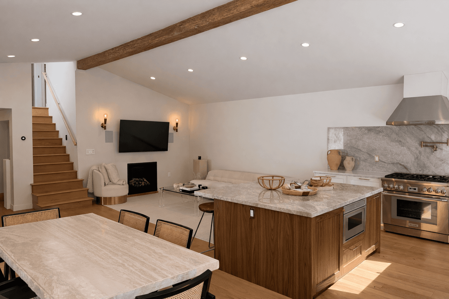 Dining area with red chairs and a view of the living room