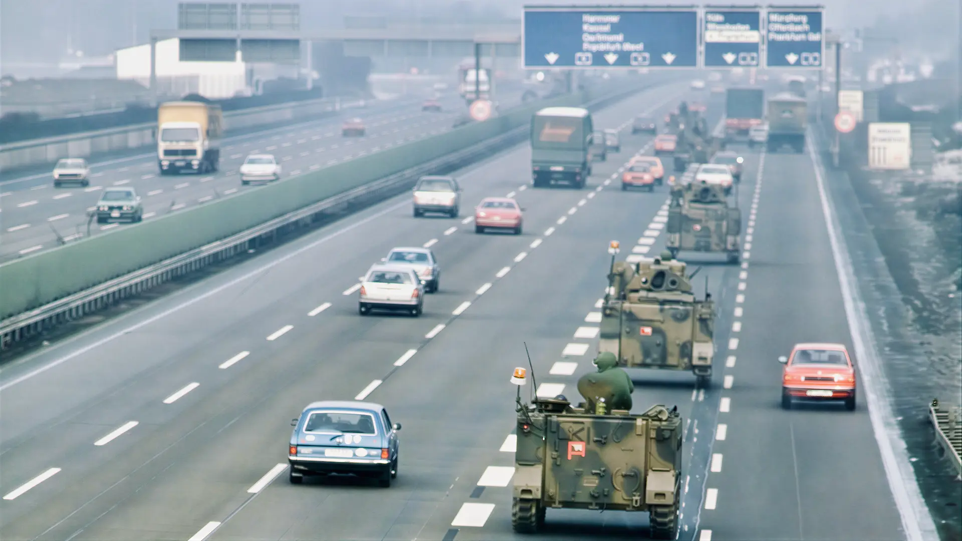 U.S. armored vehicles convoy along a German autobahn during a Cold War REFORGER exercise