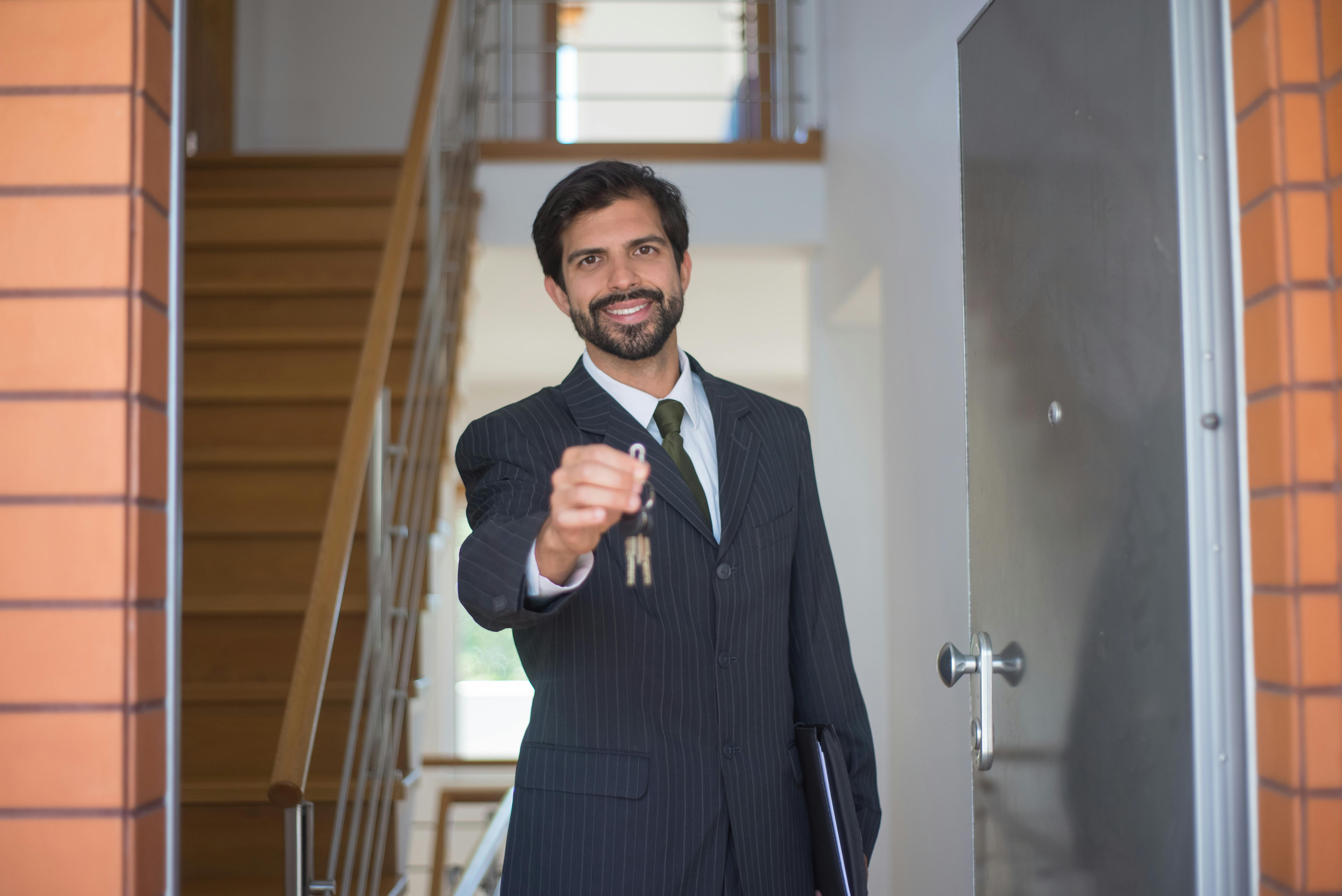 Broker in blacksuit holding keys