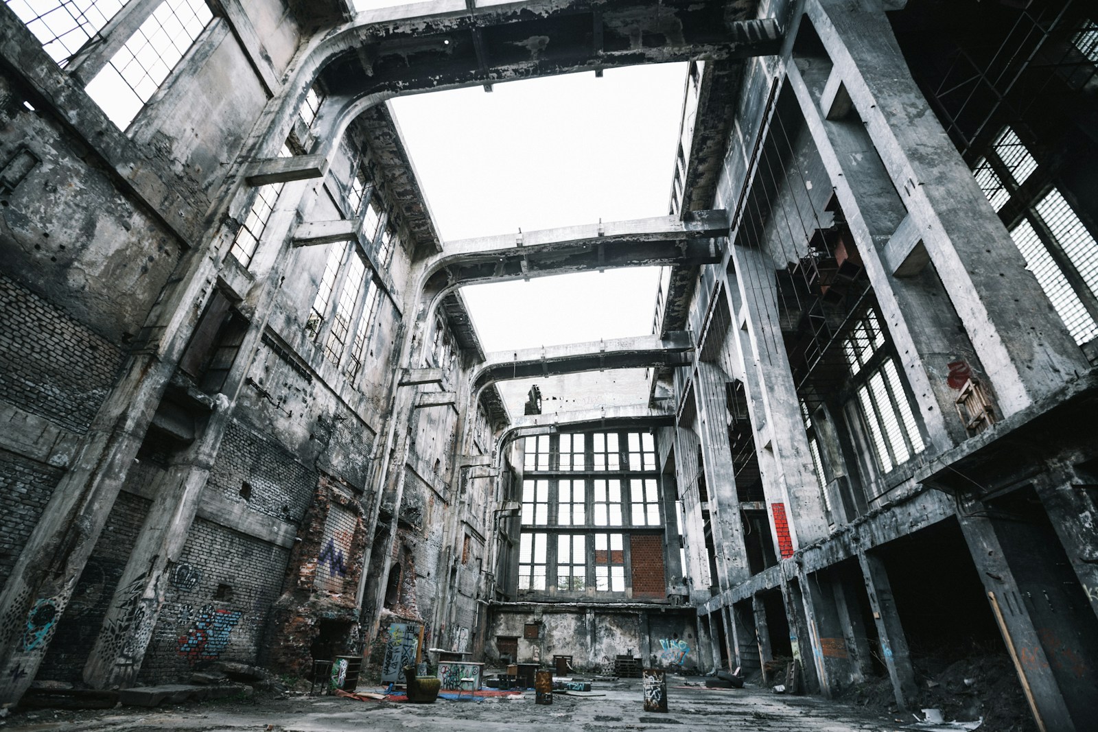 Ruined industrial hall with a broken roof and exposed steel trusses