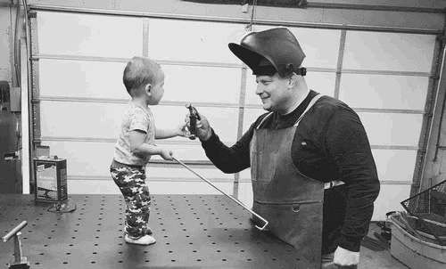 Tony and his 3 yearl old son working in the shop in Star Idaho.