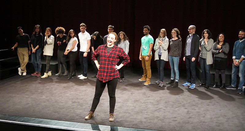 people at theater with woman in front