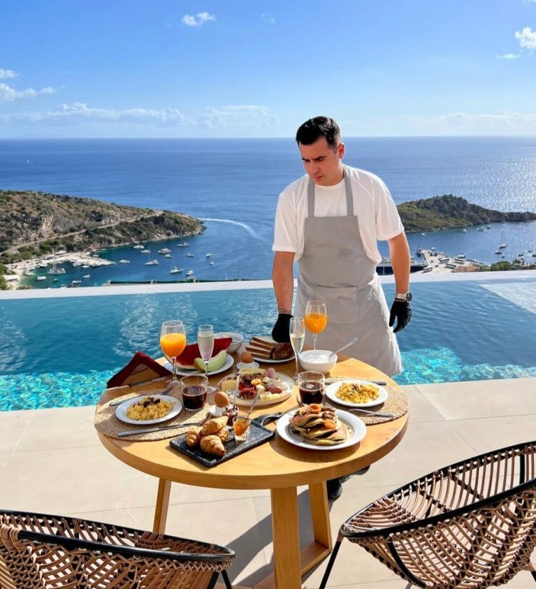 Close-up of a dark green leaf showing its textured surface and central vein against a muted background.