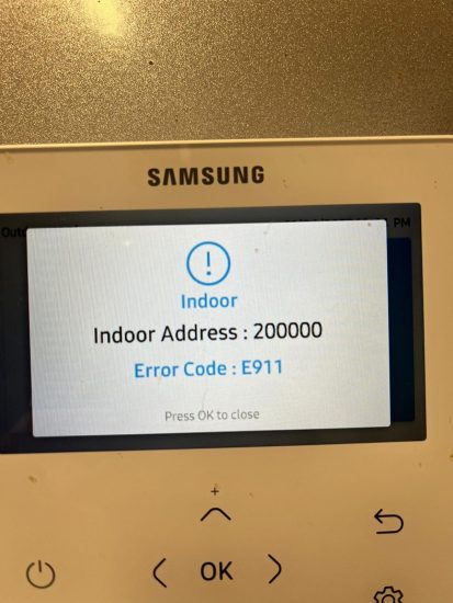Samsung heat pump indoor controller displaying E911 error code and indoor address 200000 on screen