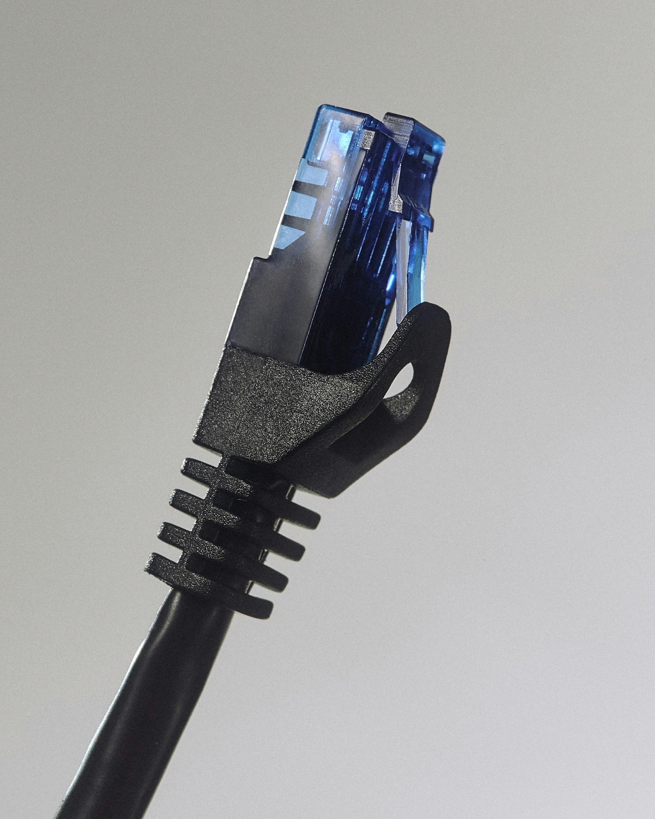 A black Ethernet cable with an RJ45 connector plug visible.