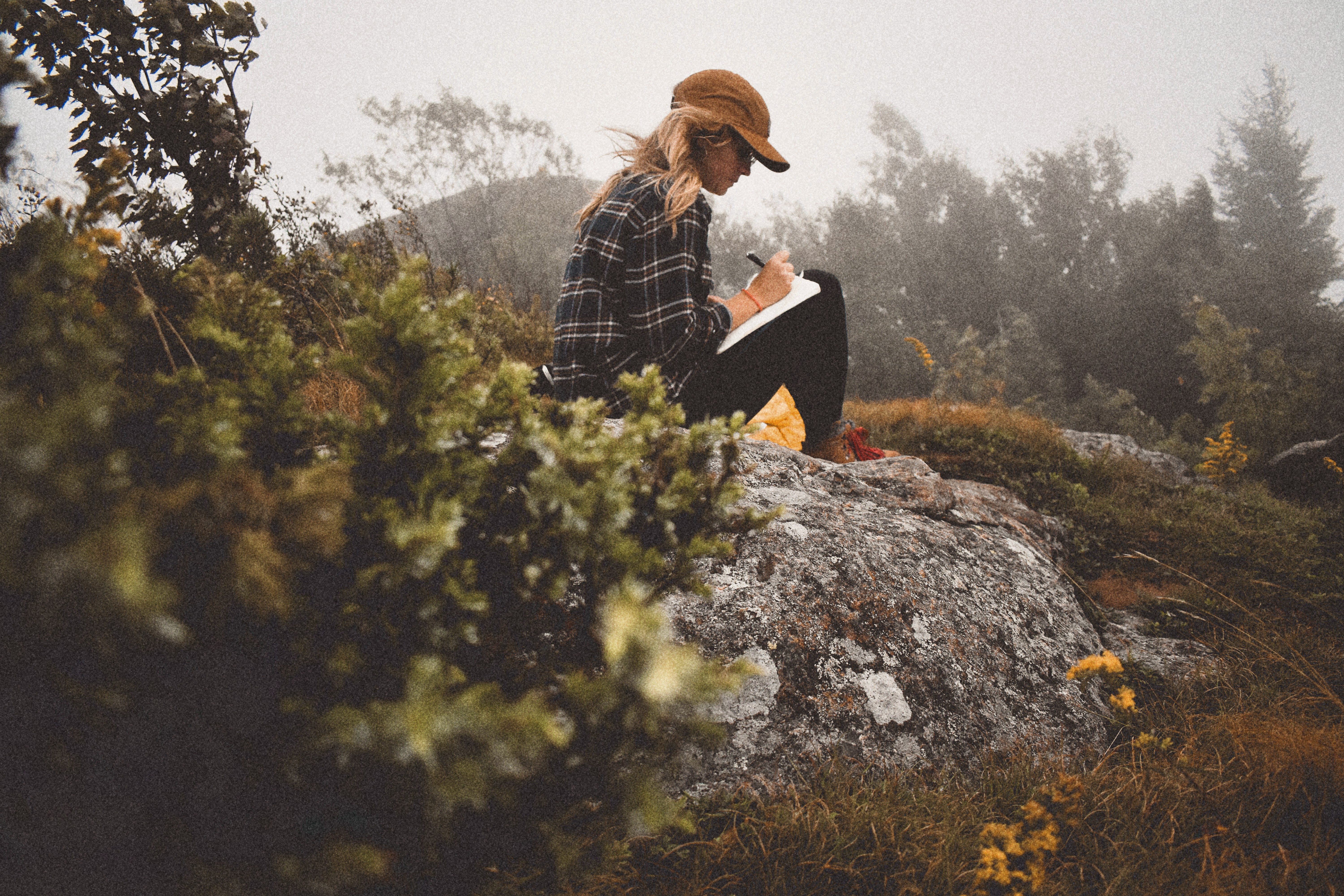 A silhouette of a person standing amidst vibrant swirling colors of teal and orange.