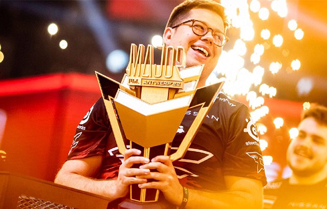 Person sitting in a modern office in front of a wall covered with notes and sketches.