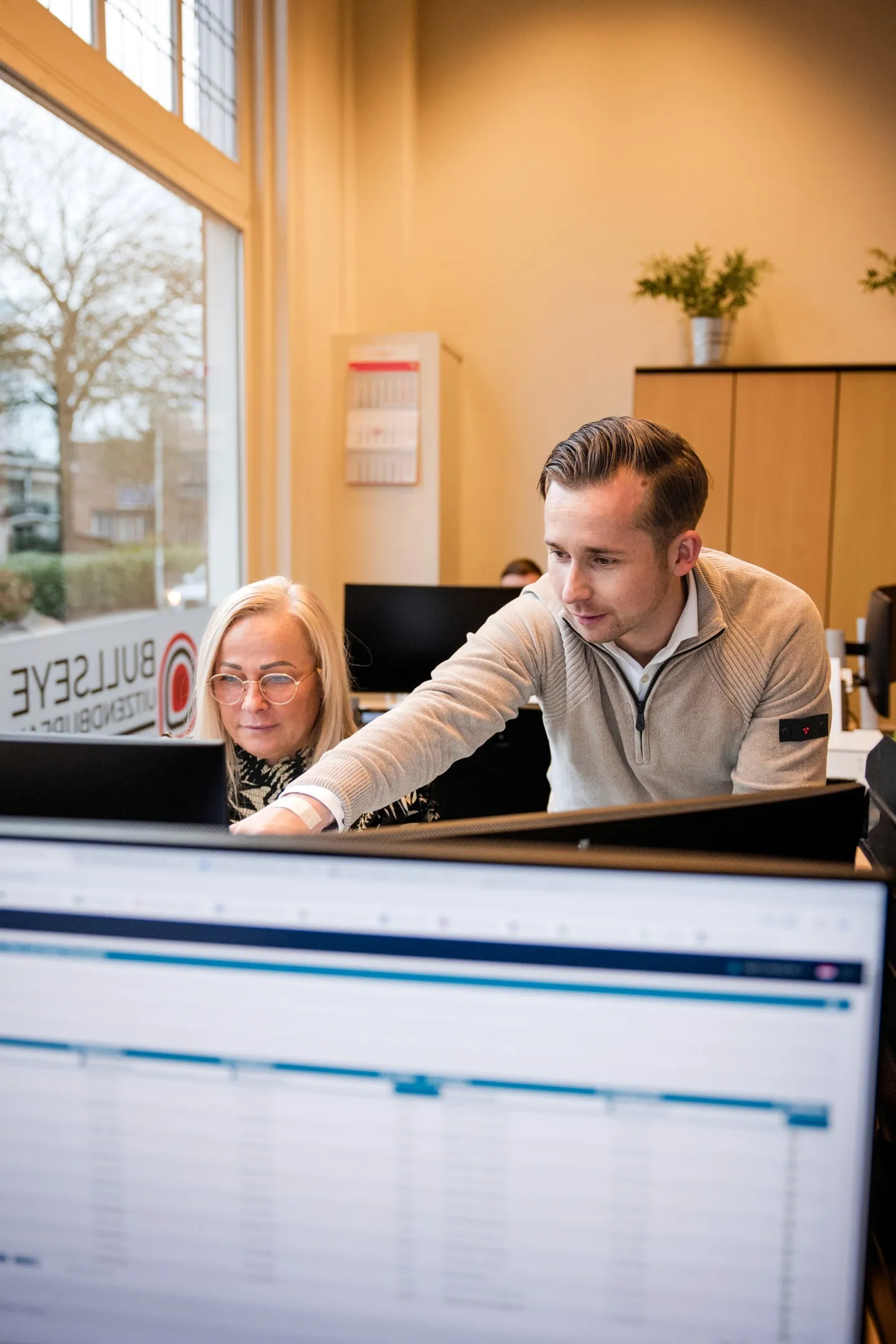 man in green and black plaid long sleeve shirt holding red and black cordless hand drill