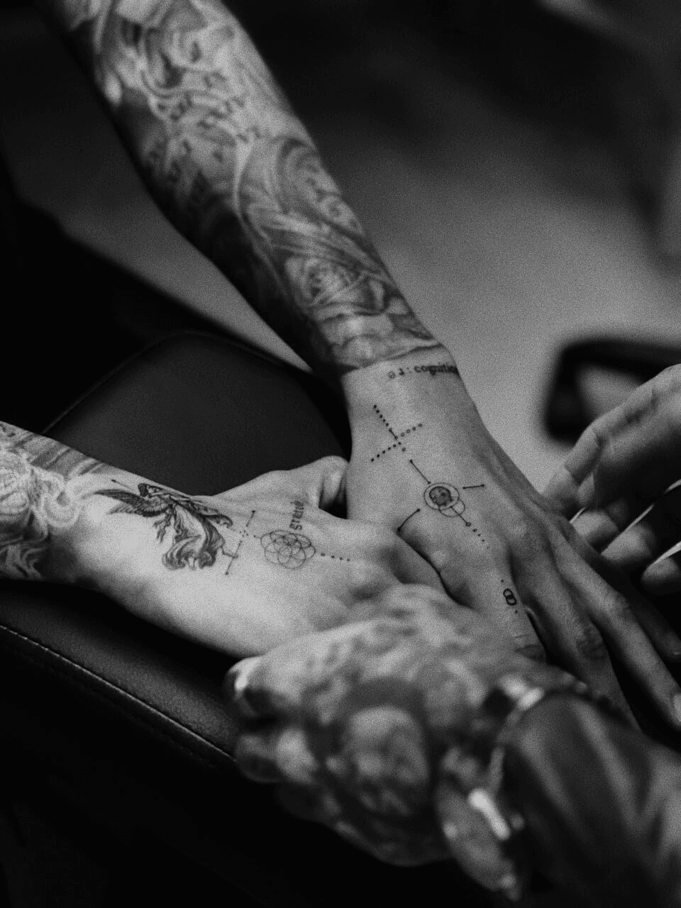 Woman in white sweater posing against wood wall