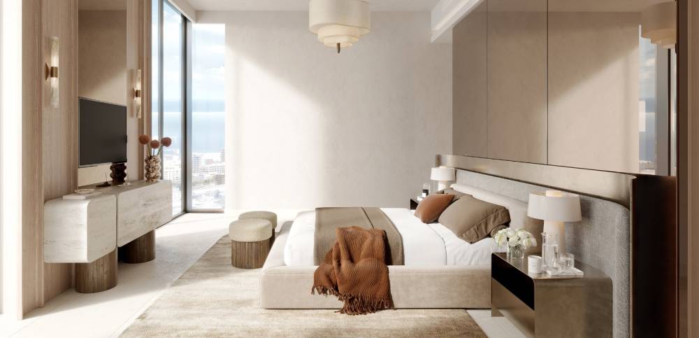 Elegant bedroom with a large window that frames the city view, including Portside Square in the distance.