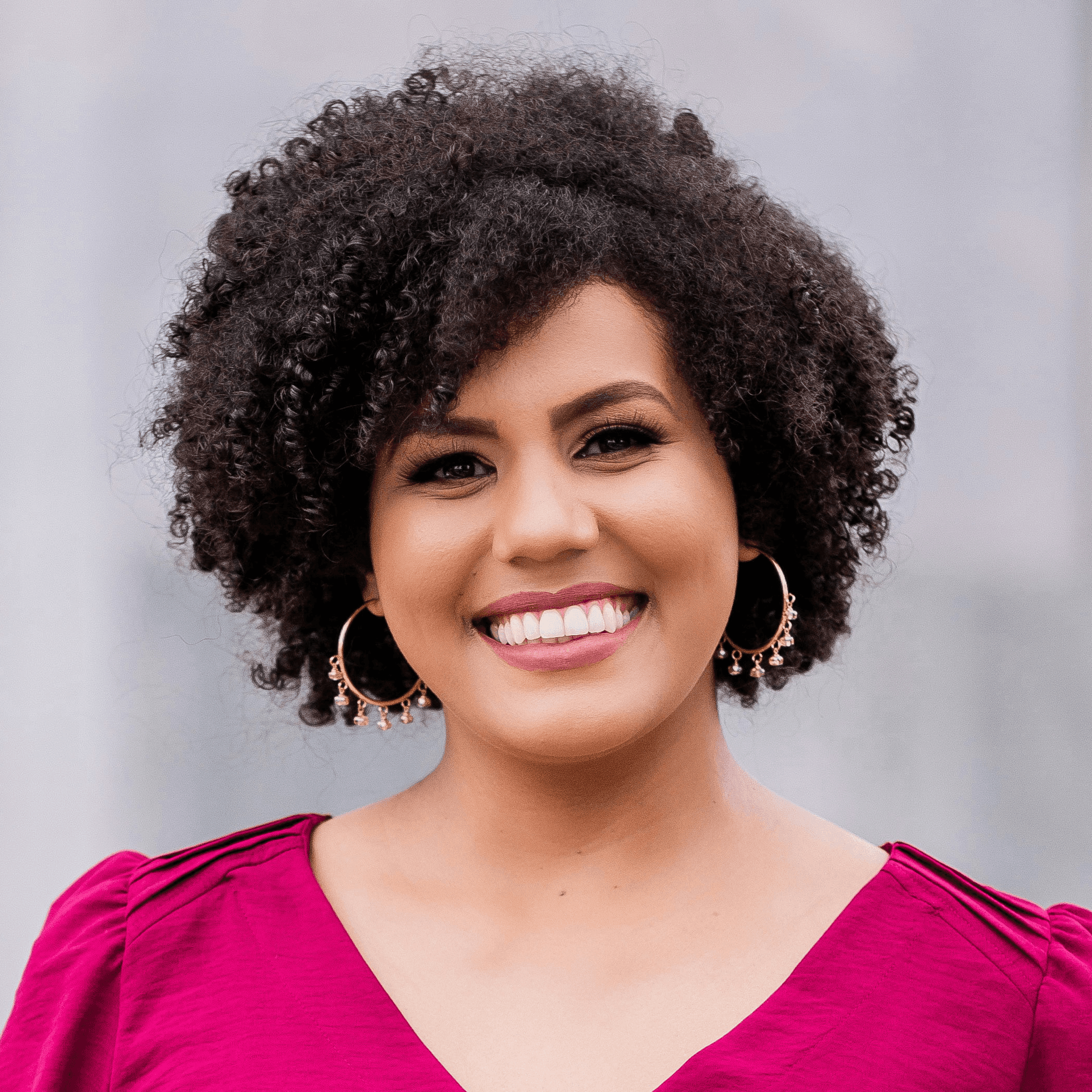 woman in red long sleeve shirt standing near white wall during daytime