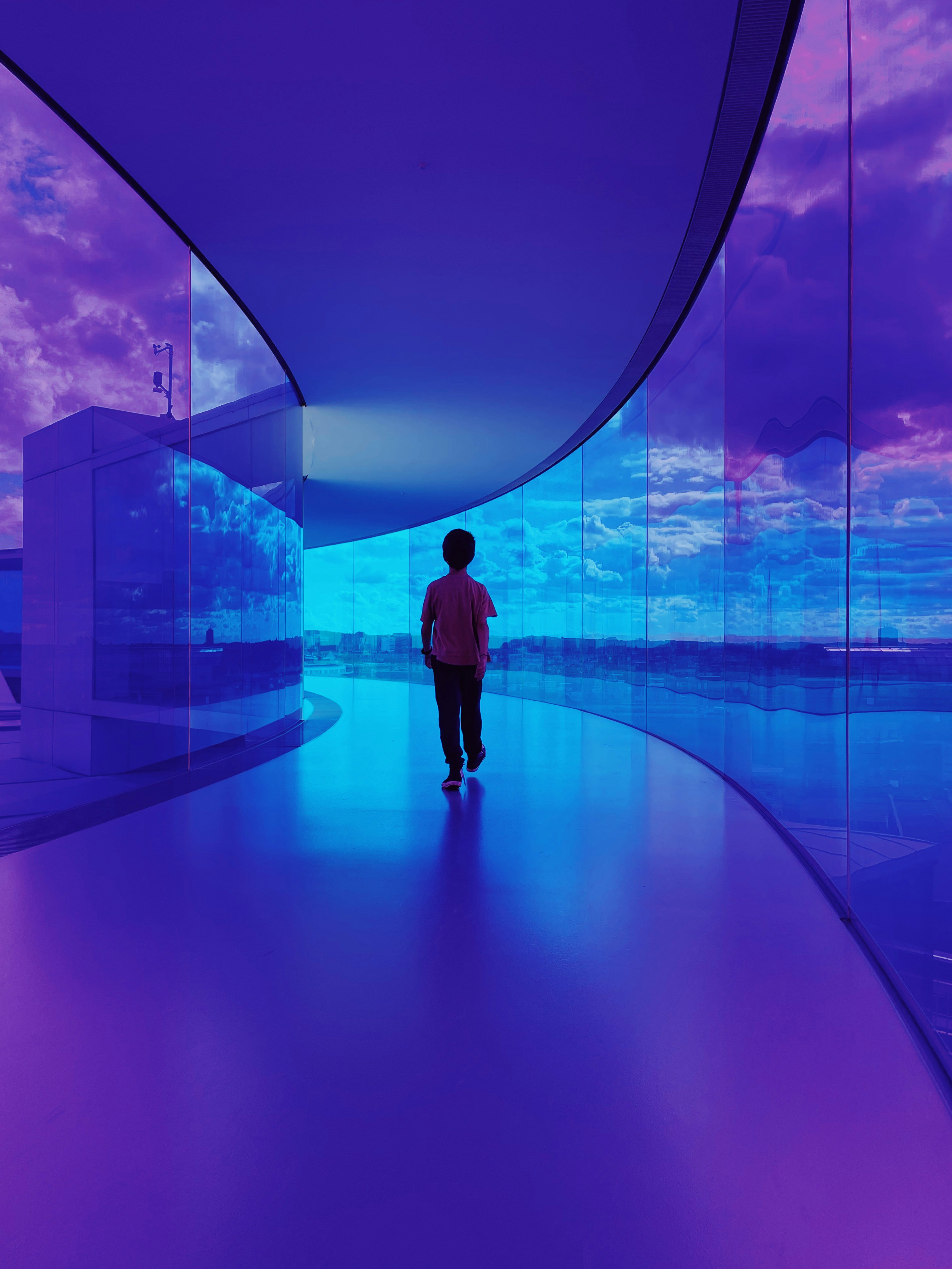 a person standing in a room with a large glass wall